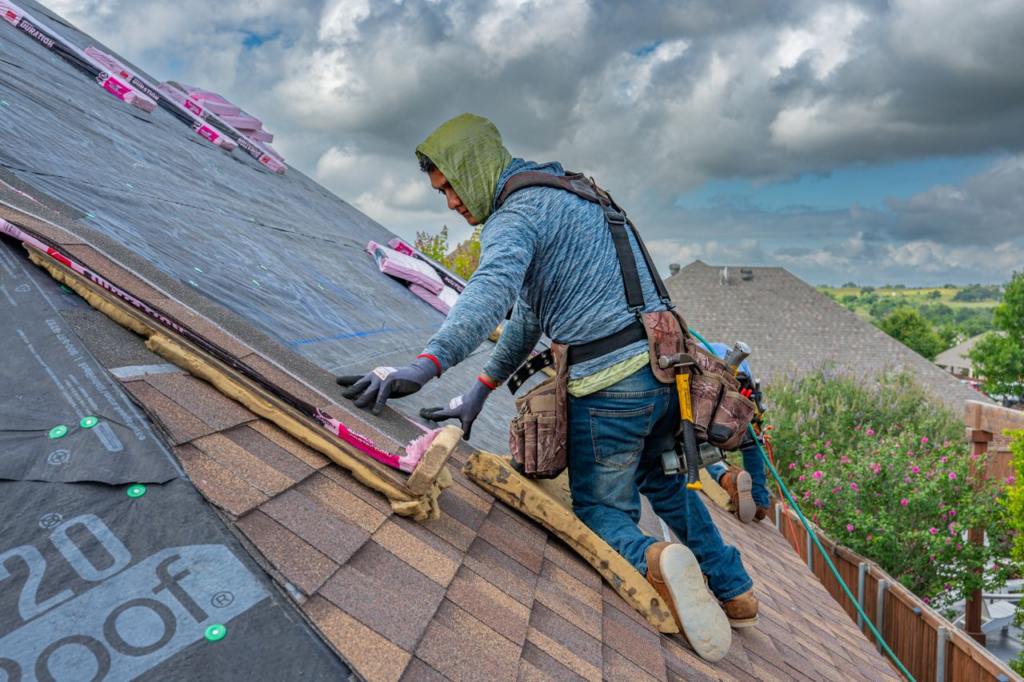 Professional inspecting residential roof shingles